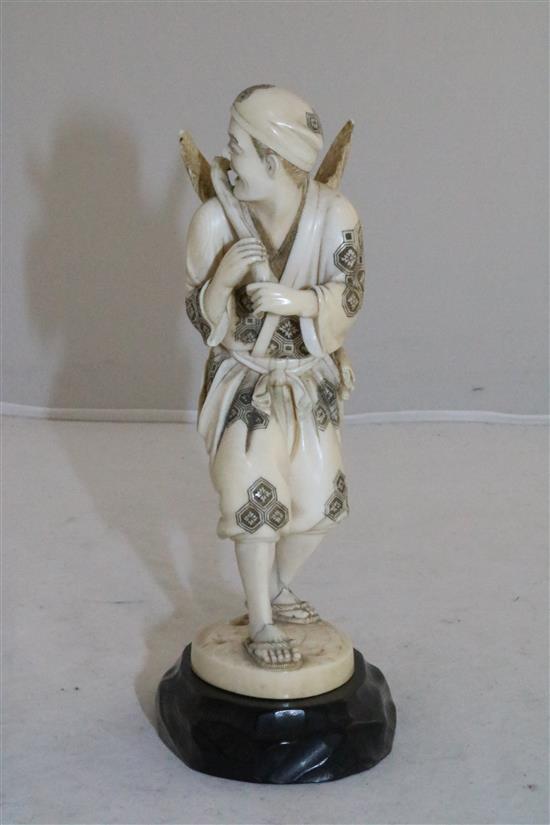 A Japanese ivory group of a cormorant fisherman, Meiji period, 15.5cm, losses and repair, wood stand